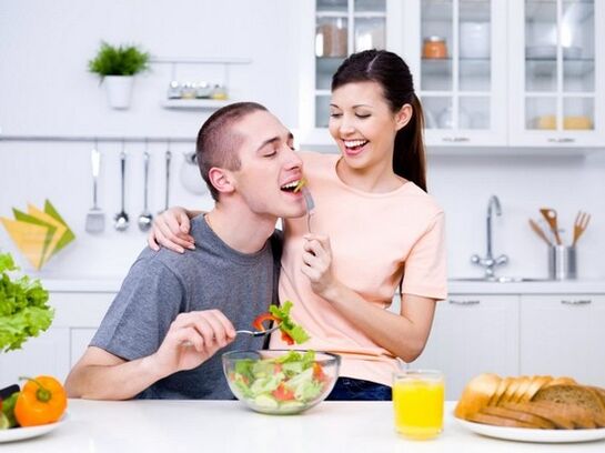 The girl feeds her man with products to increase potency