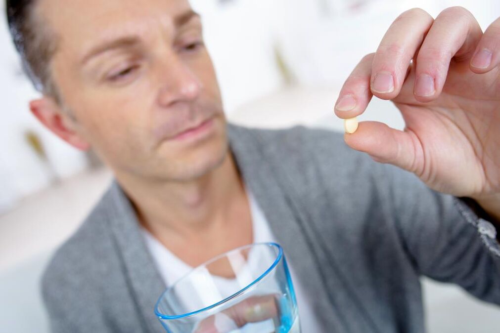 a man takes a pill to increase potency